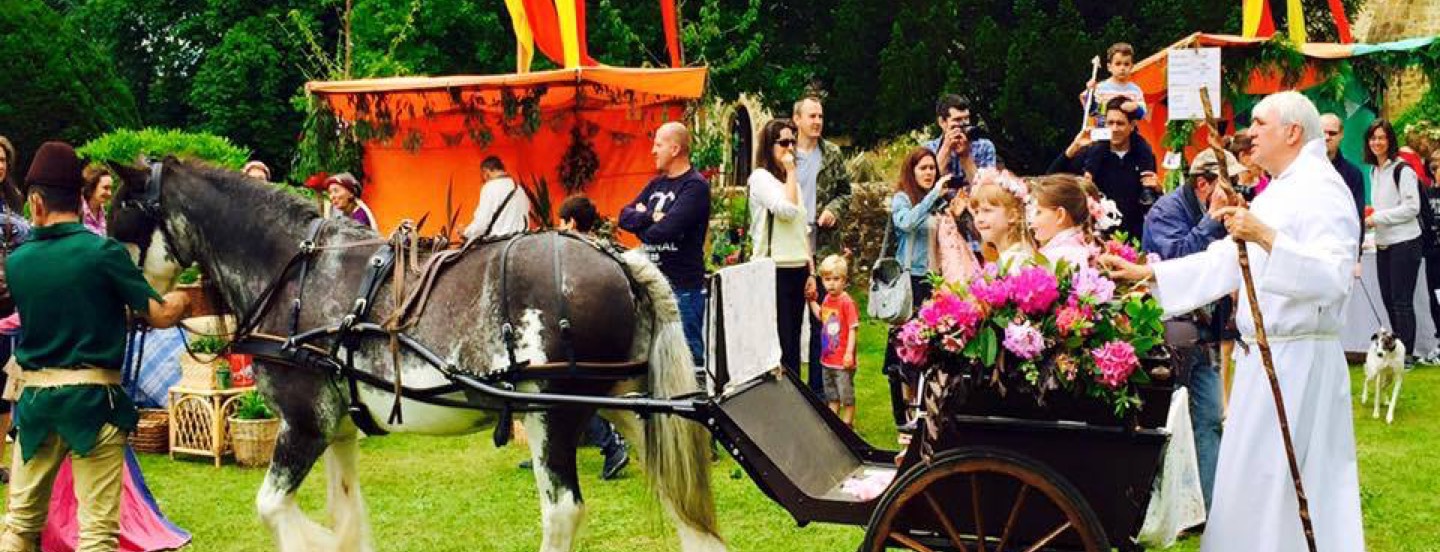 Opening procession for the Abinger Medieval Fair with the pony and trap, all in costumes and background stalls