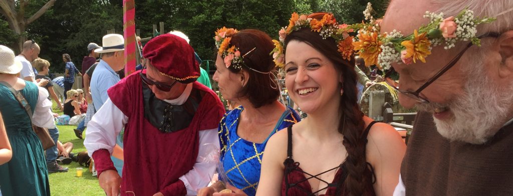 Colourful costumes and hair bands of fresh flowers worn by local stall helpers