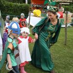 children arrive on the green in the procession