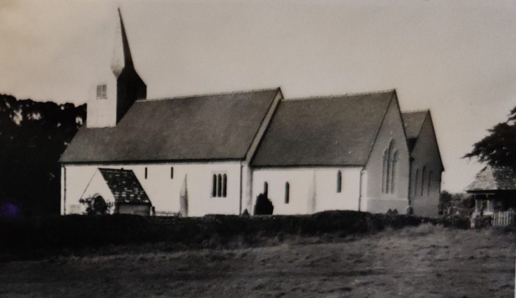 St James's Church rebuilt shown from the green with only small bushes in front of it